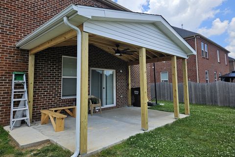 Custom structural awning with vinyl siding built over a side entrance